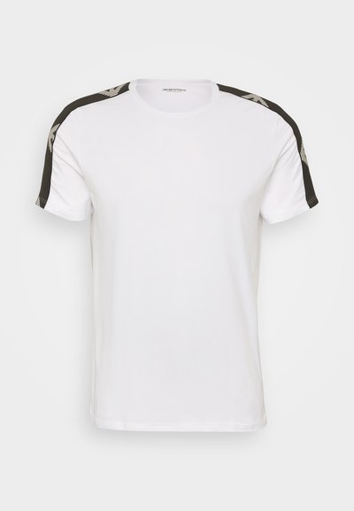 White T-shirt with black striped shoulder accents and a subtle graphic pattern. Made of soft cotton, featuring a crew neckline and short sleeves.
