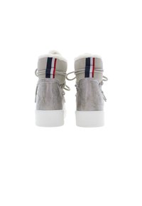 High-top sneakers in gray suede with white fur trim, featuring a navy, red, and white stripe on the back and a white rubber sole.