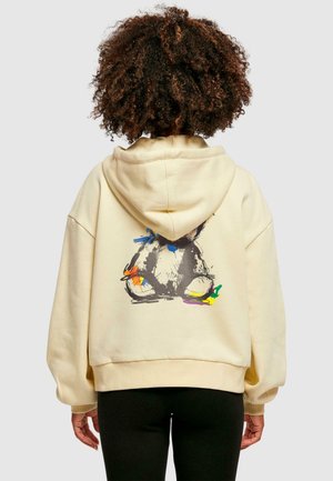 Cream-colored hooded sweatshirt with a loose fit, featuring a colorful rabbit design on the back. Soft texture and ribbed cuffs.