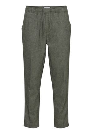 Pantalons de jogging verts, fuselés, en tissu texturé, dotés d'une taille élastique avec cordon de serrage et de poches latérales.