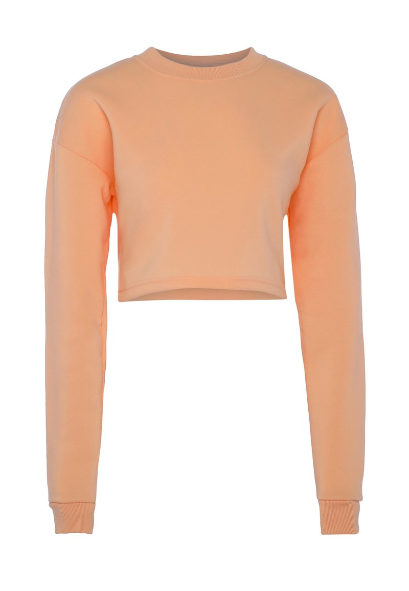 Persikofärgad kortärmad sweatshirt med långa ärmar samt ribbade manschetter och krage, visad mot en vit bakgrund.