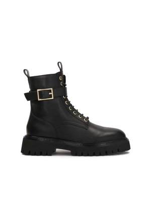 Black leather ankle boot with round toe, gold hardware, lace-up front, and a buckle accent on the ankle. Thick, textured black sole.