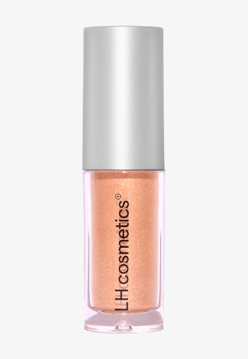 Flytande highlighter med en transparent glaskontainer och ett silverlock. Produkten har en skimrande persikofärg med fina glittrande partiklar.
