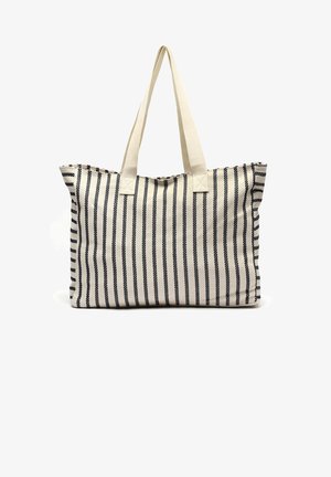 Beige en zwart gestreepte stoffen draagtas met brede beige handvatten en een rechthoekige bodem.
