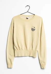 Sudadera amarilla corta con un logotipo redondeado que presenta olas y "ROXY 1990". Hecha de una tela suave con puños y dobladillo acanalados.