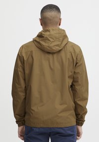 Brown waterproof jacket with a hood, elastic cuffs, and a drawstring waist. Smooth texture and simple design, displayed from the back.