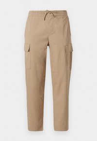 Pantalons cargo beiges en coton, dotés d'une taille élastique avec cordon de serrage, de deux poches latérales et d'une coupe décontractée.