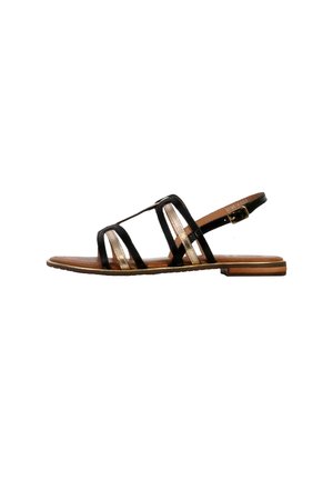Sandal piatta con suola marrone, cinturini neri e metallici dorati, e fibbia regolabile alla caviglia, mostrata in profilo laterale su sfondo bianco.