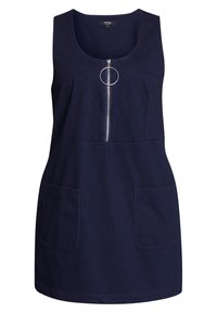 Laivastonsininen hihaton mekko, jossa on etuvetoketju ja suuri pyöreä vetoketjun henkseli, sekä kaksi etutaskua. Suora leikkaus, polvipituinen.