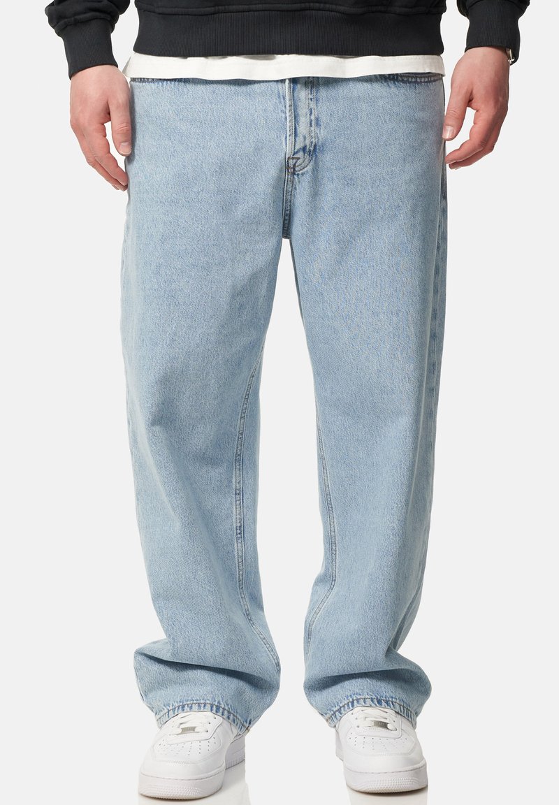 Light blue denim jeans with a loose fit, straight leg design, and subtle fading. Finished with traditional five-pocket styling and stitching details.