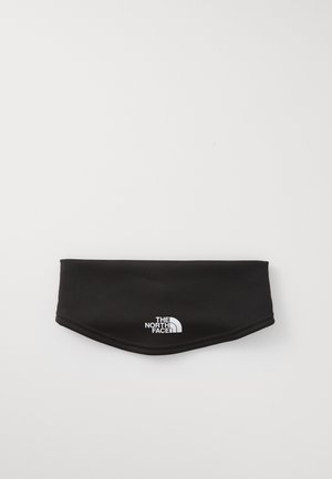 Melnas auduma galvas josla, izgatavota no elastīga materiāla, ar baltu "The North Face" logotipu frontē, ar gludu tekstūru un izliektu formu.
