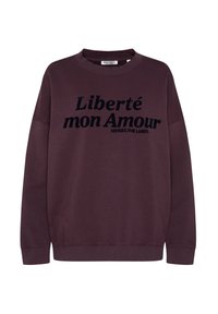 Maroon sweatshirt with ribbed cuffs and neckline. Features black text "Liberté mon Amour" prominently displayed on the front. Soft fabric texture.