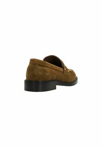 Brown suede slip-on shoe with a rounded toe and decorative stitching, featuring a low black heel and smooth textured upper.