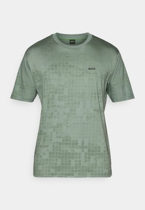 Green short-sleeve t-shirt made from smooth fabric, featuring a grid pattern and a black "BOSS" logo on the left chest area.
