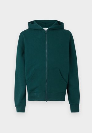 Green zip-up hoodie made of soft fabric, featuring a kangaroo pocket, ribbed cuffs, and a simple logo on the chest.