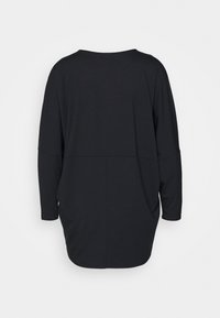 Loose black long-sleeve top with dropped shoulders and rounded hem, shown from the back against a plain background.