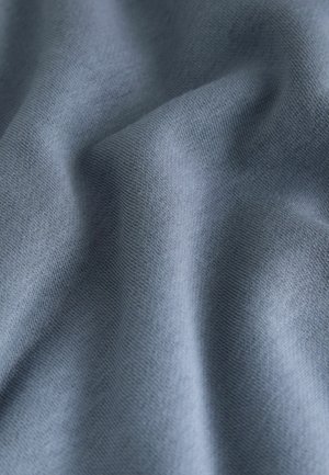 Soft, textured fabric in a muted blue shade, showcasing a smooth surface with subtle ribbed patterns.