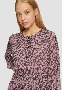 Rosenmuster Kleid mit leichtem Stoff, langen Ärmeln, einer Knopfleiste vorne und einem elastischen Bund für eine lockere Passform.