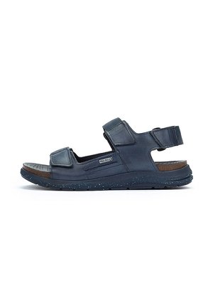 Sandalia azul marino con correas ajustables de velcro, plantilla acolchada, plantilla texturizada y suela de goma moteada.