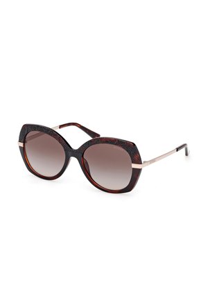 Tortoiseshell sunglasses with a wide cat-eye shape, gradient lenses, and textured detailing on the top frame. Metal accents at the temples.