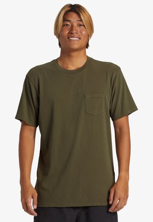 Olive green cotton t-shirt with a round neckline, short sleeves, and a front chest pocket. Soft texture with a relaxed fit design.