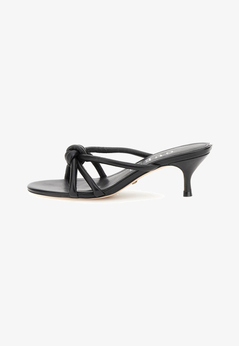 Sandali con tacco in pelle nera, design annodato, punta aperta e tacco a stiletto sottile. Le cinghie testurizzate si incrociano sopra il plantare.