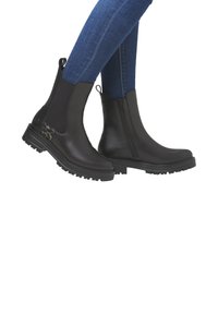 Black ankle boots with a smooth leather upper, side zipper, and ribbed elastic panels; textured sole for traction, featuring a leopard print accent.