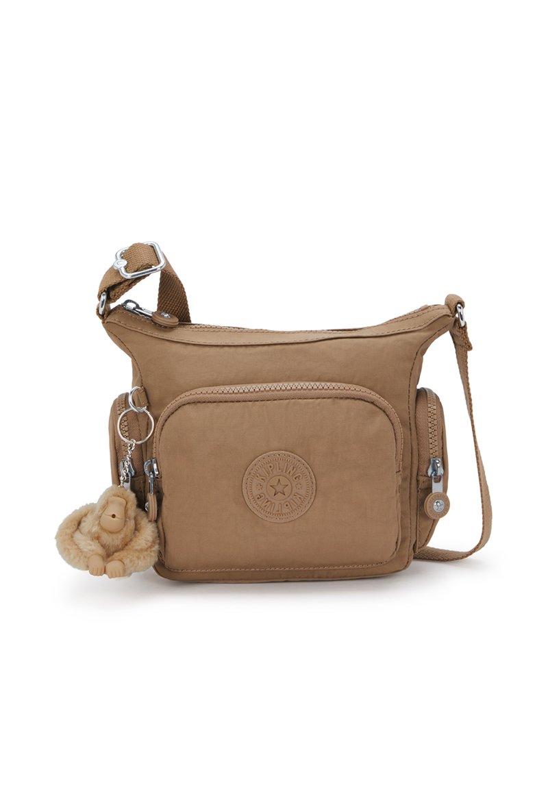 Borsa a tracolla marrone chiaro realizzata in tessuto morbido con una finitura testurizzata. Presenta una tasca frontale, chiusura con zip e un portachiavi a forma di scimmia in peluche.