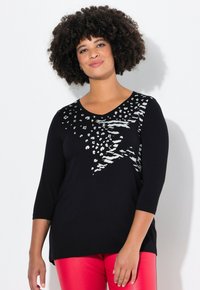 Maglia nera a maniche lunghe con un design di stampa animale argento sulla parte superiore sinistra, con scollatura a V e vestibilità morbida.