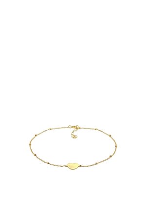 Delicate gold chain bracelet featuring small beads and a central smooth heart-shaped charm with a lobster clasp and extender chain.