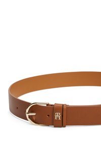 Brown leather belt featuring a gold-tone metal buckle and a small logo accent. Smooth texture with multiple adjustment holes.