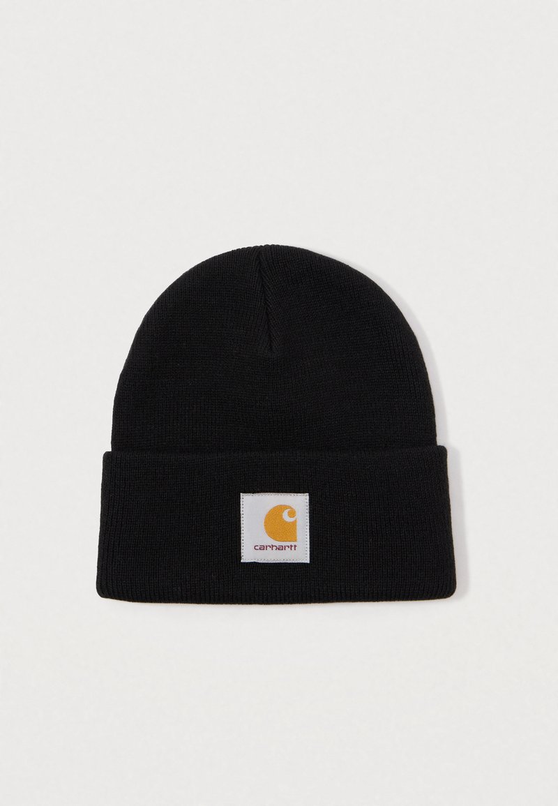 Bonnet en tricot noir avec revers et un patch carré blanc présentant un logo Carhartt jaune au centre avant.