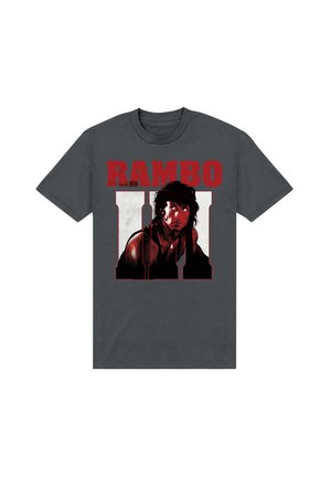 Šedé bavlněné tričko s velkým grafickým potiskem obličeje postavy a tučným červeným textem "RAMBO III" nahoře a dole.