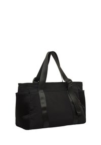 Sac fourre-tout noir en tissu robuste avec une texture lisse, doté de deux poches latérales et de sangles ajustables pour des options de transport polyvalentes.