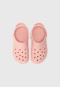 Pink plastic clogs with perforated ventilation holes, rear strap, and textured footbed for comfort; smooth surface with rounded edges.