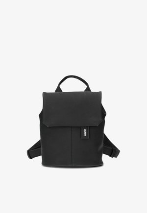 Small black backpack with flap closure, top carry handle, adjustable shoulder straps, and a visible brand tag on the front.
