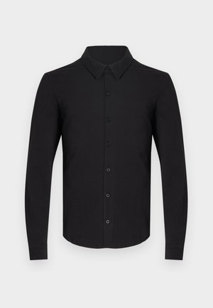 Must pikkade varrukatega särk pehmest kangast, millel on nööbitav esiosa, klassikaline krae ja nööbitavad mansetid. Siledapinnaline, mustriteta.