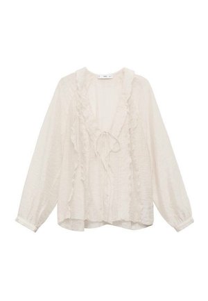 Bluză albă cu mâneci lungi, confecționată dintr-un material ușor, având accentefranjuri de-a lungul gâtului în V și pe față, cu o croială lejeră.