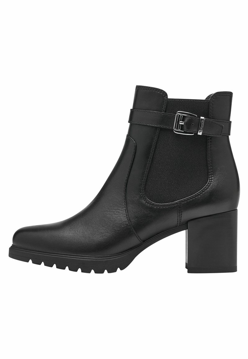 Bottine en cuir noir avec un talon bloc haut, des panneaux élastiques sur les côtés et une boucle décorative sur la bride de la cheville. Semelle texturée pour une bonne adhérence.