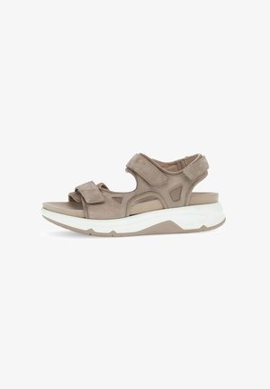 Beige suede sandals with adjustable straps, cushioned insole, and a thick white rubber sole, featuring cutouts for breathability.