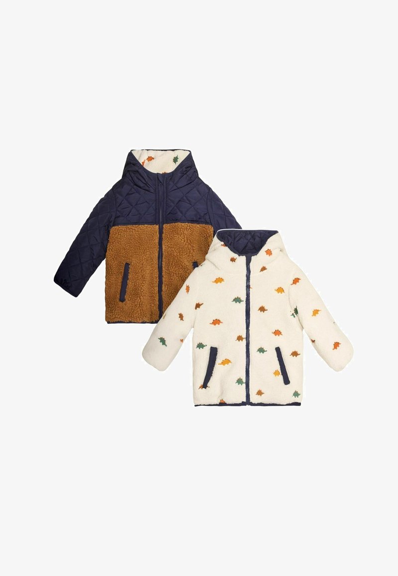 Umkehrbare Kinderjacke mit einer marineblauen, gepolsterten Außenseite und einer braunen Sherpa-Seite oder einer elfenbeinfarbenen Seite mit bunten Dinosauriermustern.