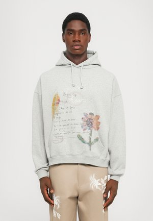 Grey hoodie made of cotton, featuring a floral graphic print and handwritten text. The design includes a drawstring hood and a kangaroo pocket.