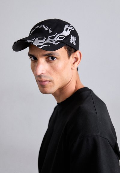 Black baseball cap with silver flame graphics and "Angels" text on the front, paired with a black long-sleeve shirt.