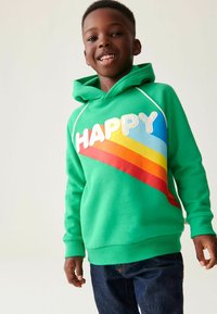 Zöld pamut kapucnis pulóver, amely multiszínű "HAPPY" grafikával büszkélkedik, piros, narancs és kék csíkokkal. Rugalmas mandzsetták és derékpánt.