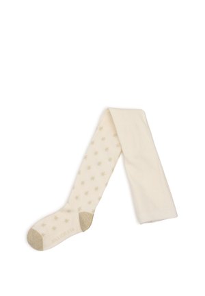 Crèmekleurige panty's met gouden sterrenpatronen, gouden glitter op hakken en tenen, plat gelegd met één been over het andere gevouwen.