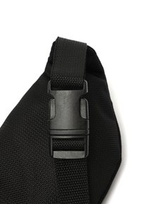 Crni remen za torbu od tkanine s teksturiranom površinom, podesivom dužinom i plastičnom kopčom za sigurno zatvaranje.
