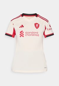 Kortærmet cremefarvet fodboldtrøje med røde akcenter, med V-hals, broderet Liverpool-mærke og "Standard Chartered" logo.