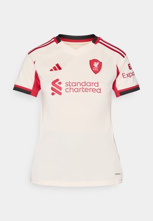 Kortermet kremfarget fotballdrakt med røde detaljer, med v-hals, brodert Liverpool-merke og "Standard Chartered"-logo.