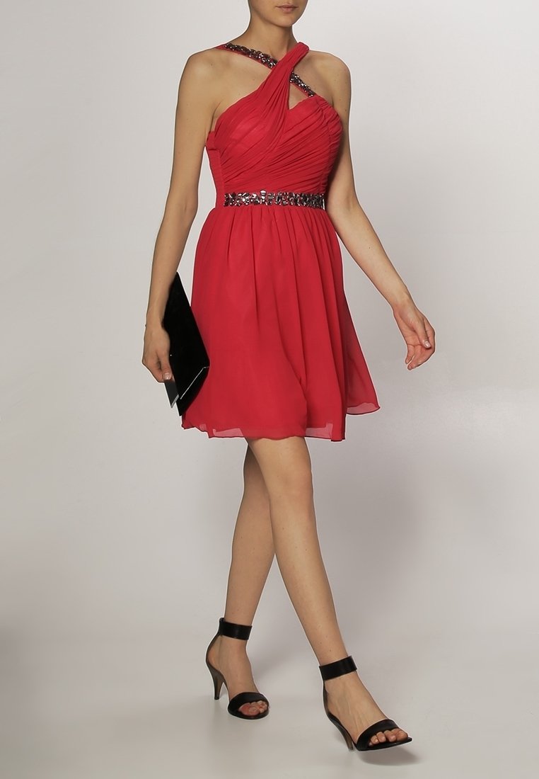 Red chiffon dress with a twisted shoulder strap design and beaded waistline, paired with black high-heeled sandals and a clutch.