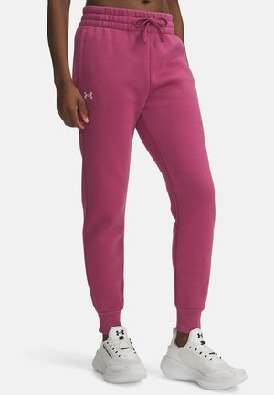 Pantaloni da sudore rosa in cotone con vita elastica, coulisse e tasche laterali. Presenta un piccolo logo bianco sul fianco sinistro.